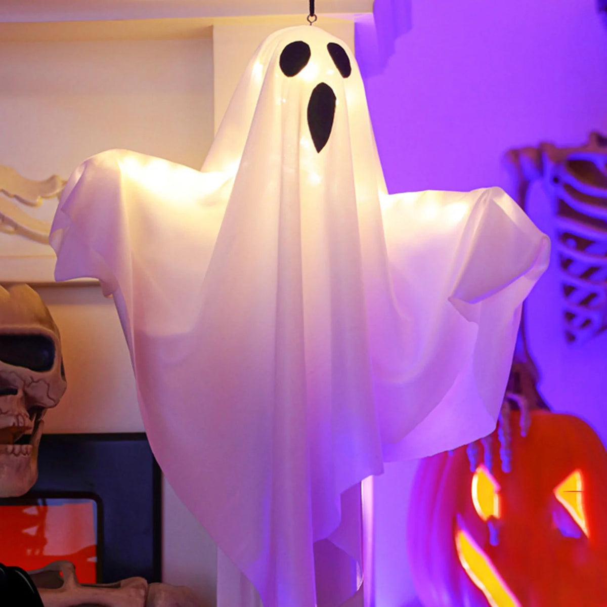 Lighted ghost Halloween decoration hanging outdoors