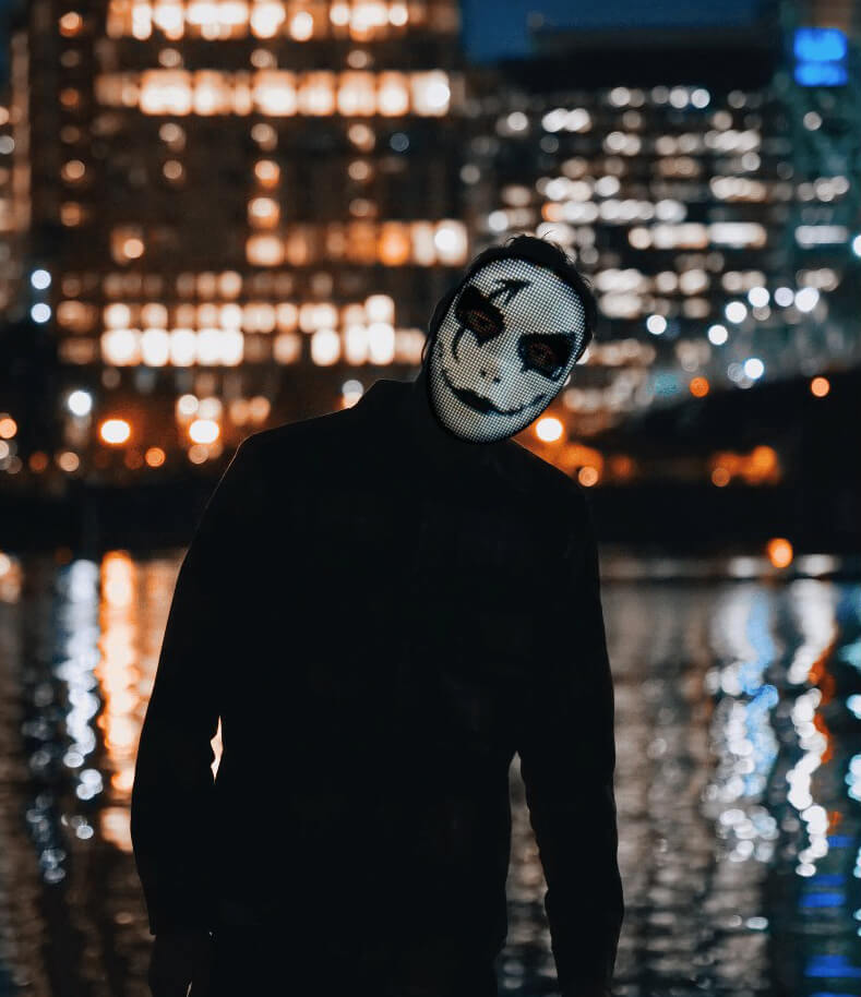 Light up mask worn at a concert with colored effects