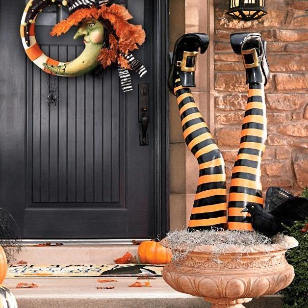 Yellow and black striped witch leg yard stakes with black buckled boots