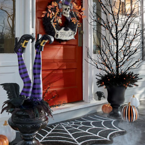 Witch leg Halloween yard stake showing curled toe and golden buckle detail