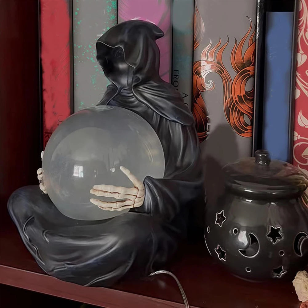 Halloween crystal ball decoration lit up on a dark shelf