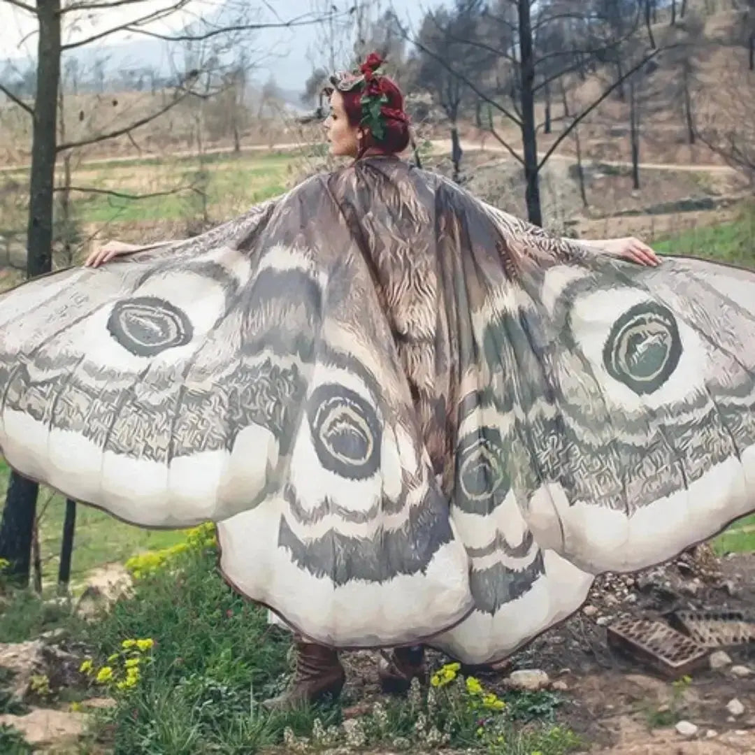 Grey moth wing chiffon cape worn with arms outstretched