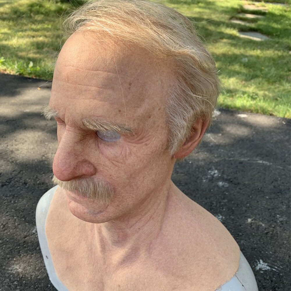 Old man mask worn with the movable mouth open