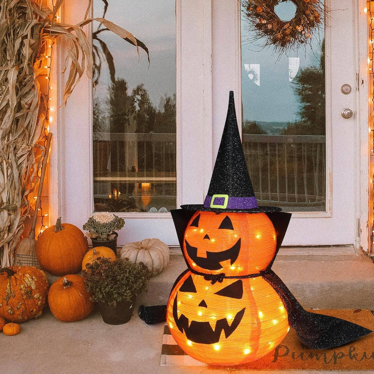 Halloween pumpkin decoration wearing the included black fabric cape
